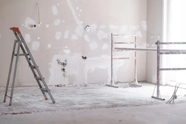 ladder-construction-equipment-standing-empty-room-illuminated-by-bright-sunlight_210545-2476