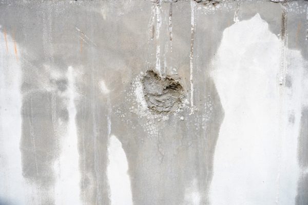 weathered-concrete-wall-with-hole-water-stains
